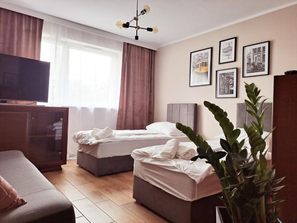 Un ou plusieurs lits dans un hébergement de l'établissement Apartament pod Miastem