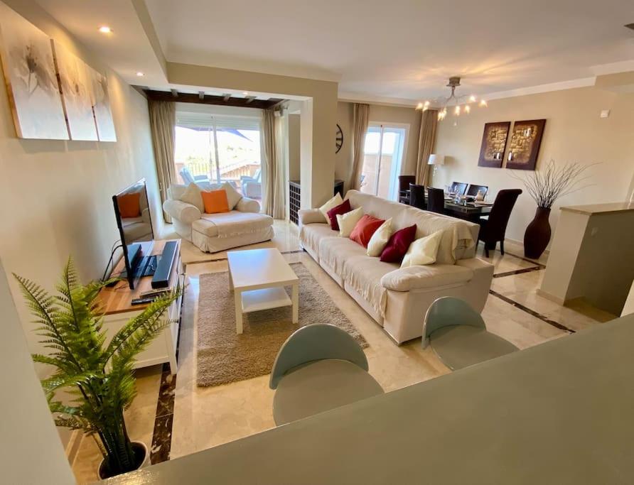 a living room with a couch and a table at Townhouse in Manilva in Manilva