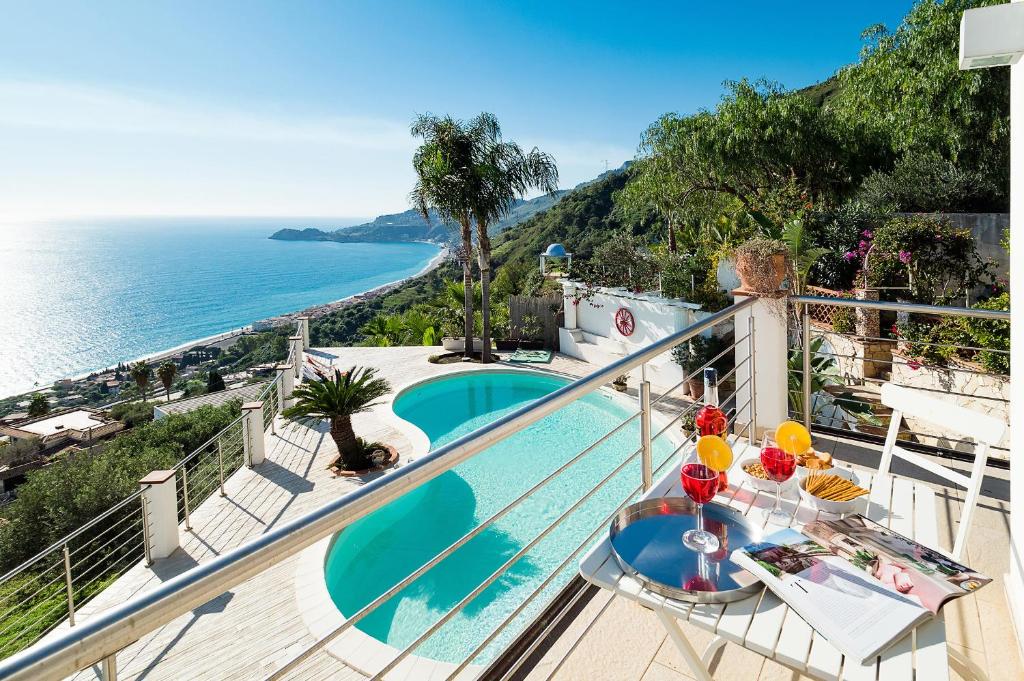 a balcony with a view of the ocean at Villa Luce in Letojanni