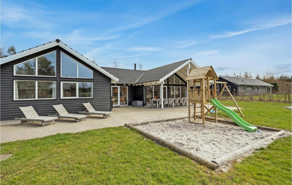 a backyard with a playground and a house at Gorgeous Home In Glesborg With Sauna in Glesborg