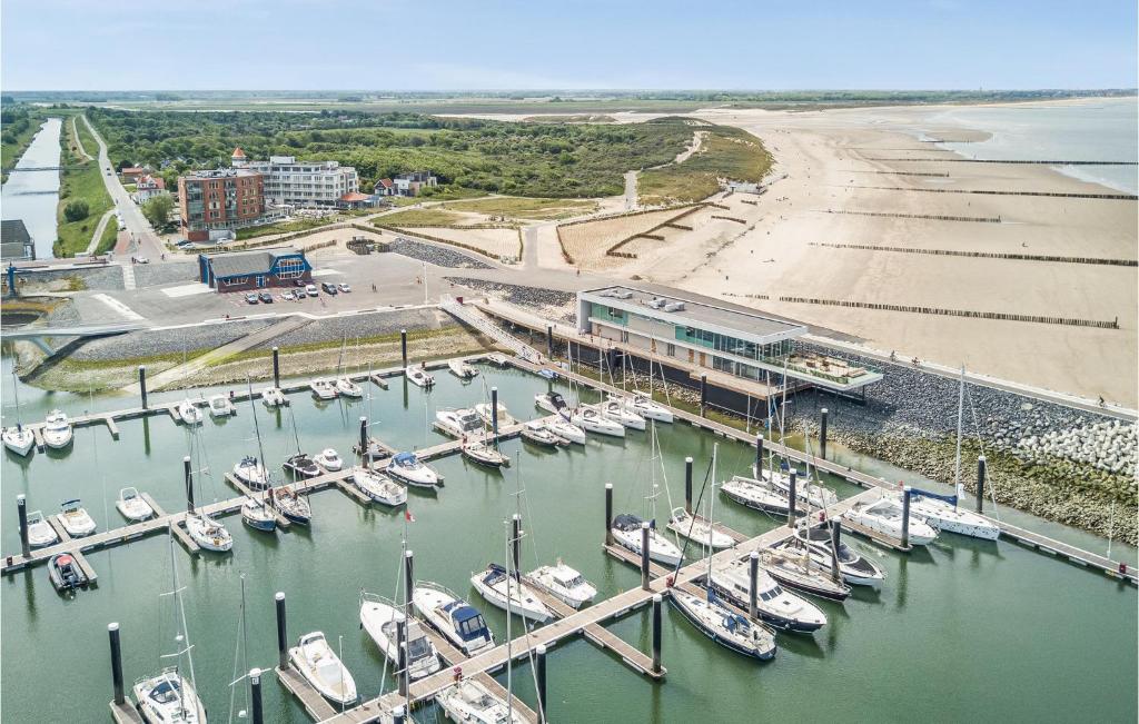 a group of boats docked in a marina next to a beach at Amazing Apartment In Cadzand-bad With Kitchen in Cadzand-Bad