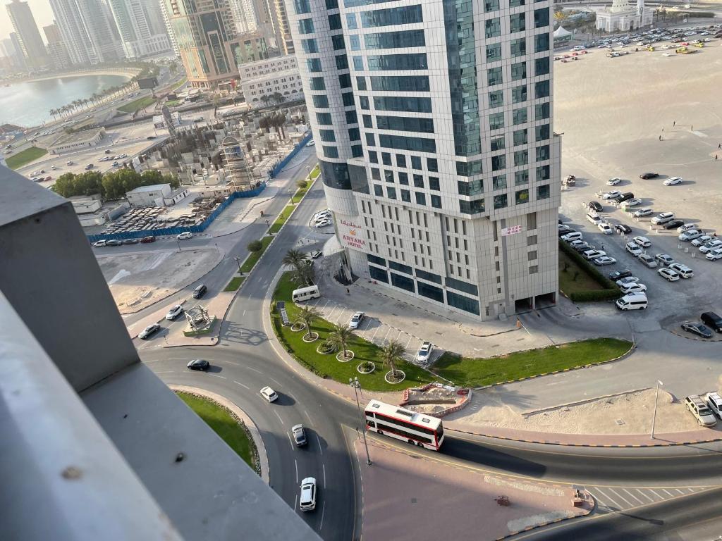 an aerial view of a city with buildings and a bus at Hostel - bedspace for Ladies سكن - سرير للبنات in Al Khān