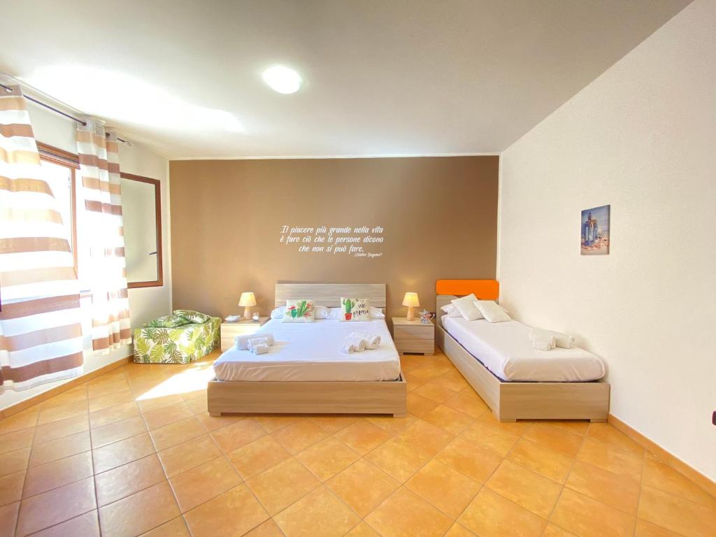 a bedroom with two beds in a room at Maison Soleil Guest House Gallipoli in Gallipoli