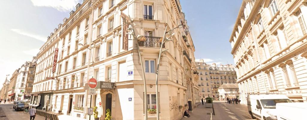 a tall building on a city street with buildings at Hotel Bristol Nord Paris in Paris