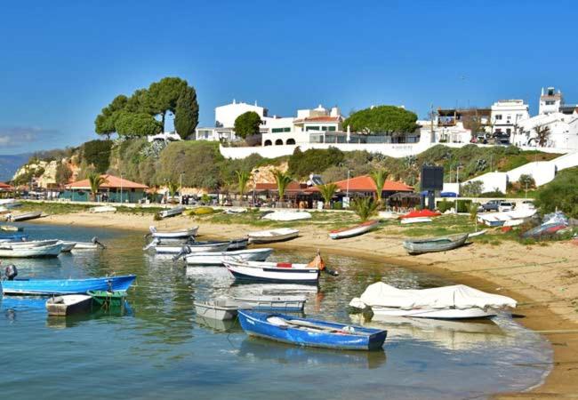 a group of boats on the shore of a beach at Alvor Experience in Alvor