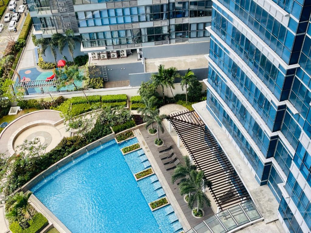 an overhead view of a large building with a swimming pool at Uptown Parksuites BGC in Manila