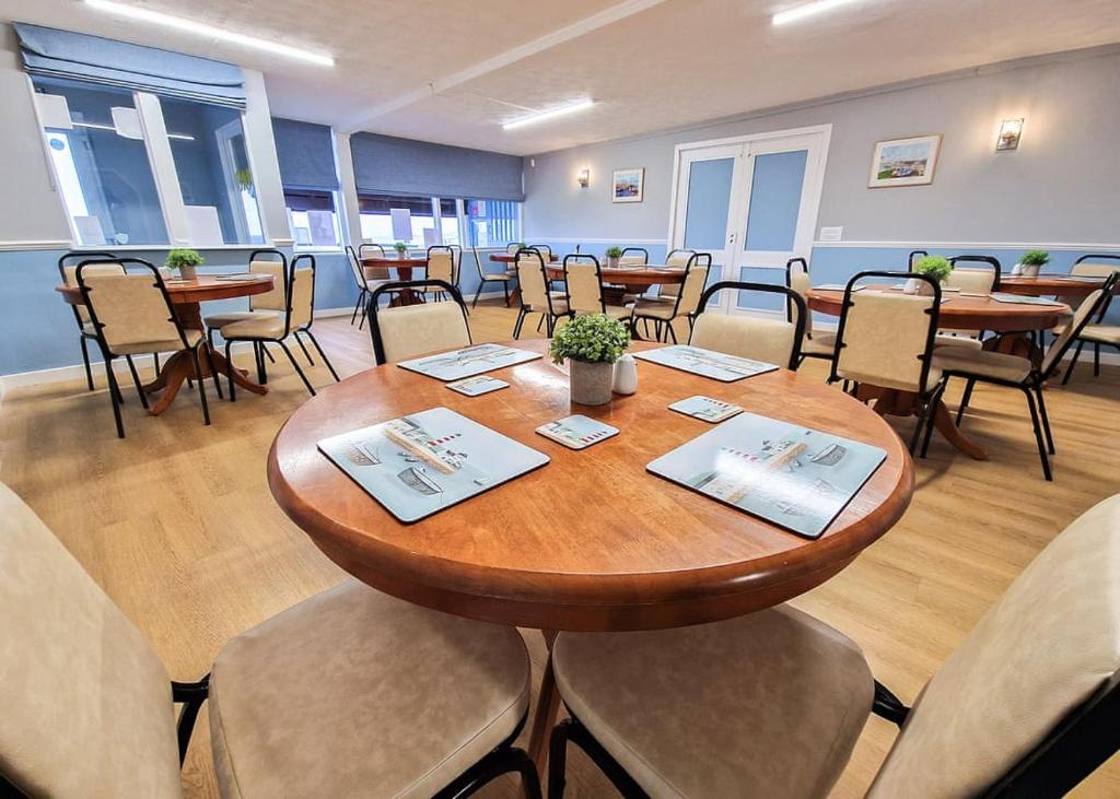 a conference room with a table and chairs at Burrowhead Holiday Village in Isle of Whithorn