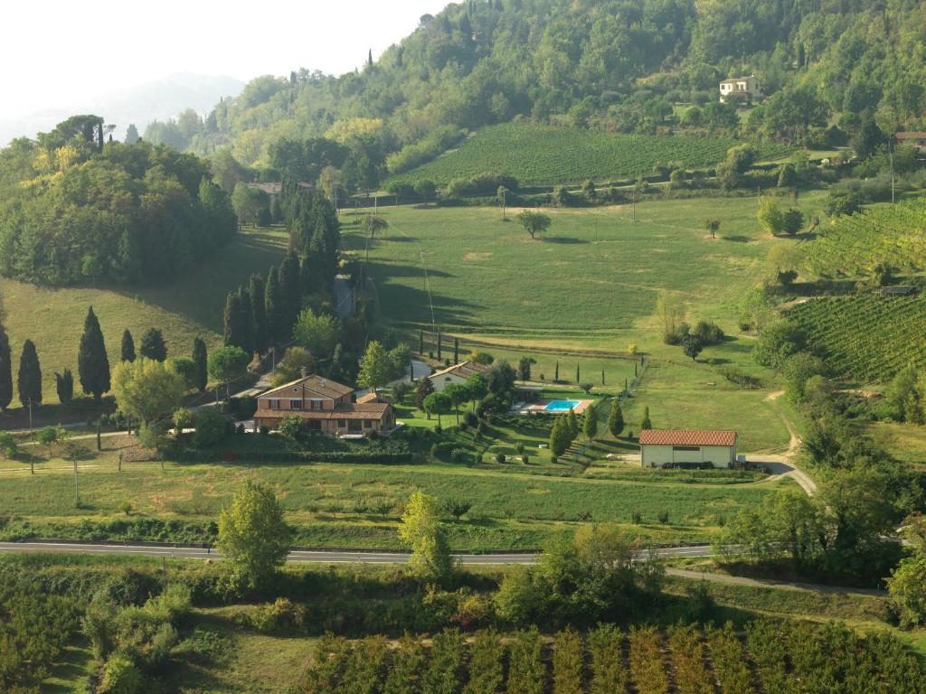 a view of a valley with a farm and a road at Relais Varnello in Brisighella