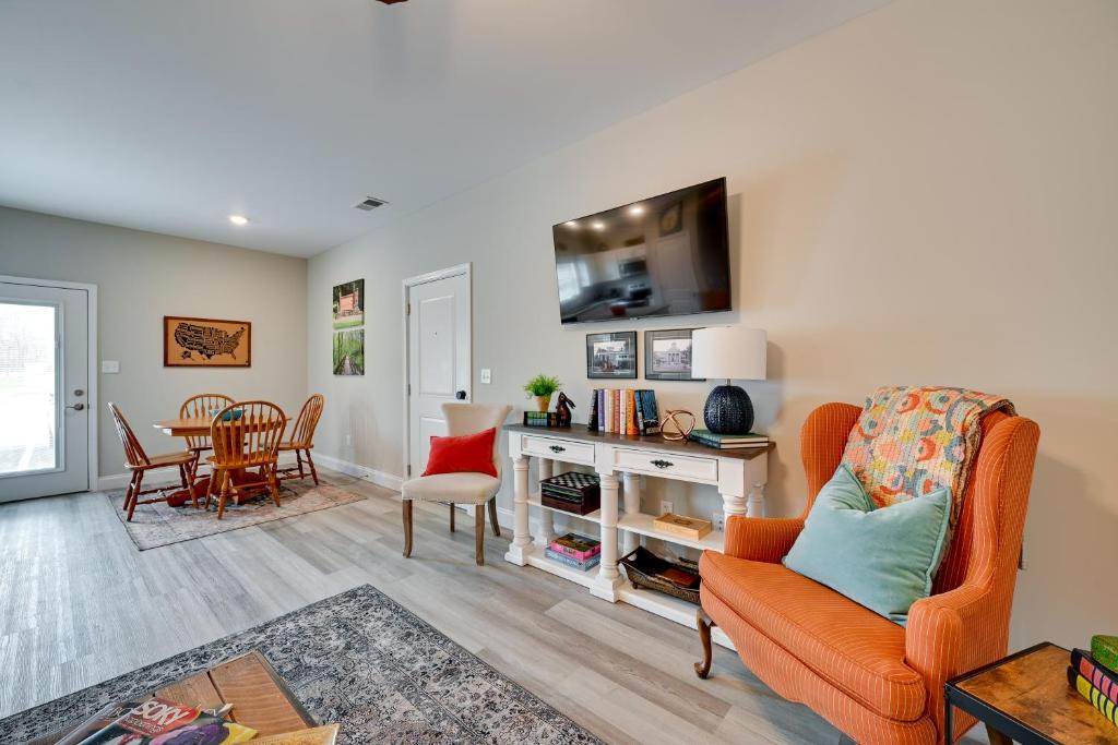 a living room with an orange chair and a table at Brownsville Vacation Rental Near National Park! in Sloans Crossing