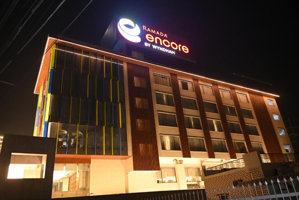 a building with a sign on top of it at Ramada Encore by Wyndham Bareilly Civil Lines in Bareilly
