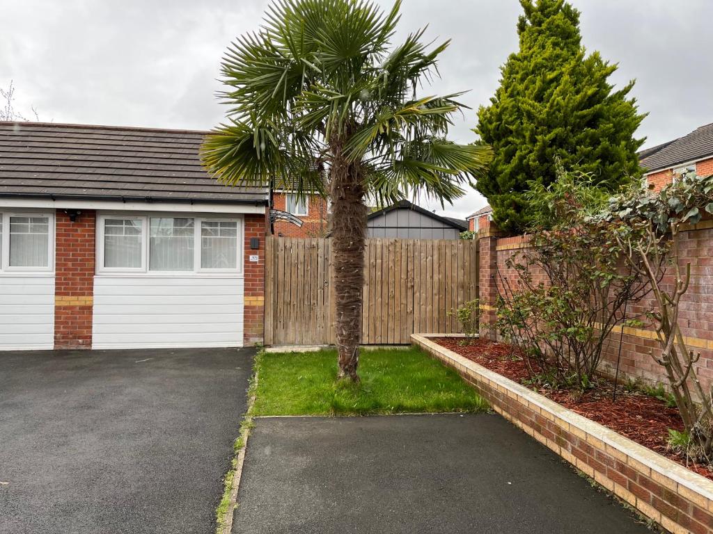 a palm tree in front of a garage at Inviting 1-Bed Studio in Manchester & feel at home in Manchester
