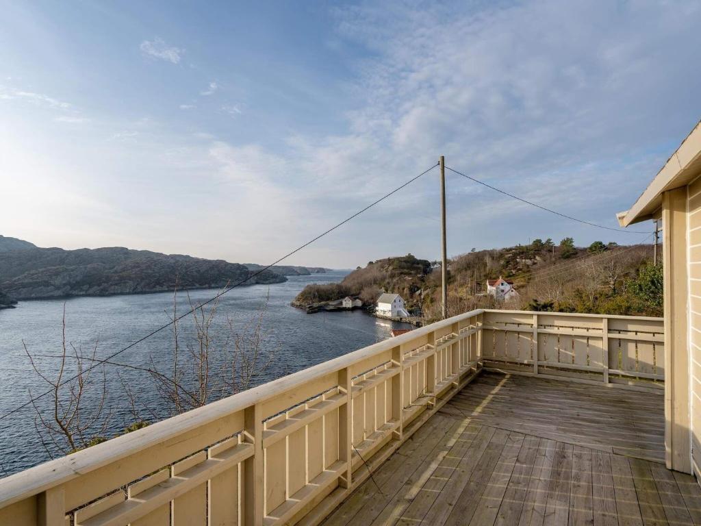 a balcony of a house with a view of a river at Holiday home FINNÅS II 