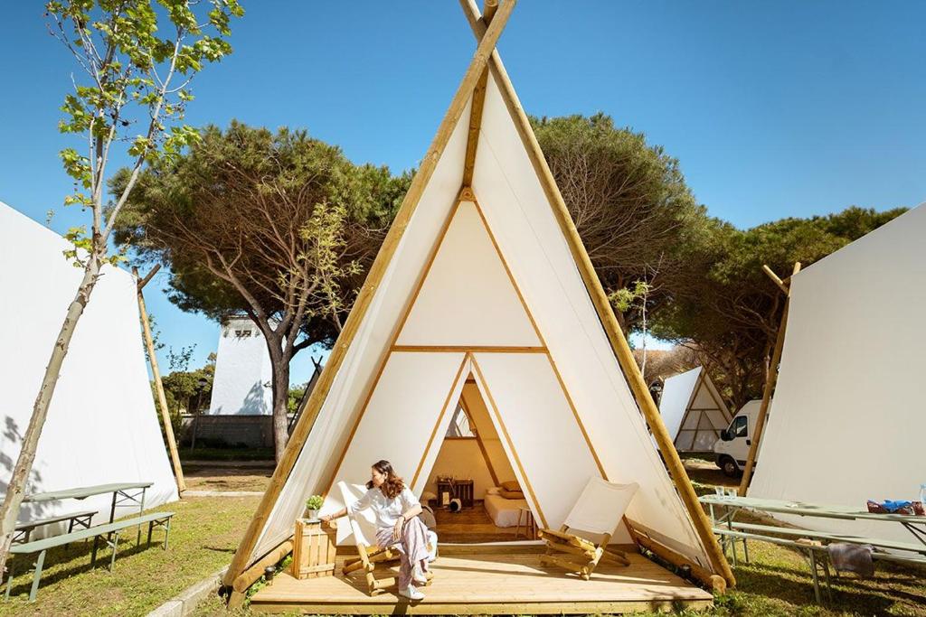 a man sitting inside of a teepee tent at Kampaoh Grazalema in El Bosque