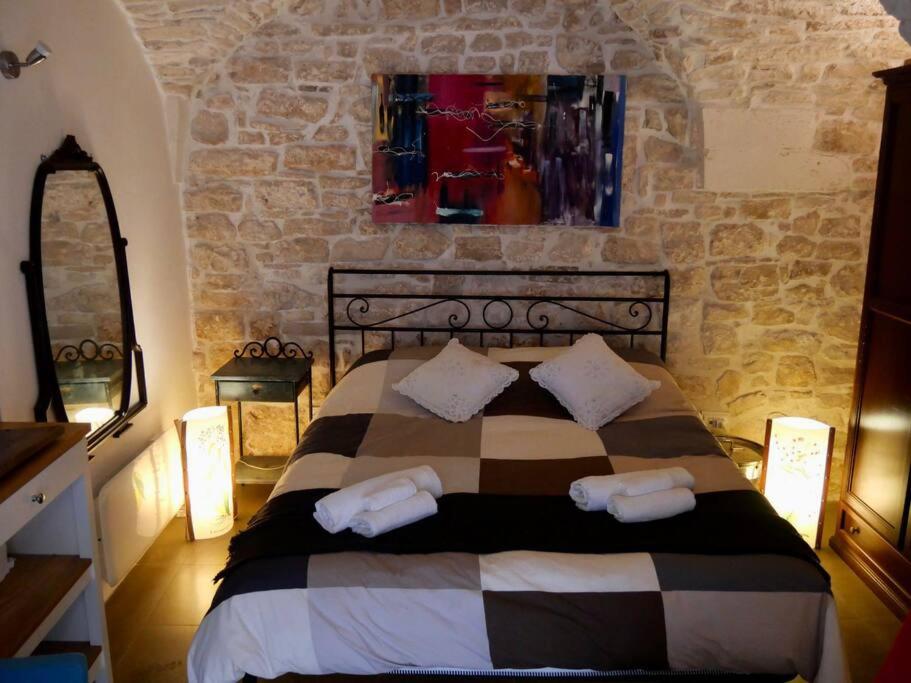 a bedroom with a bed with two pillows on it at Residenza Le Tre Volte - colazione inclusa con TicketBar in Martina Franca