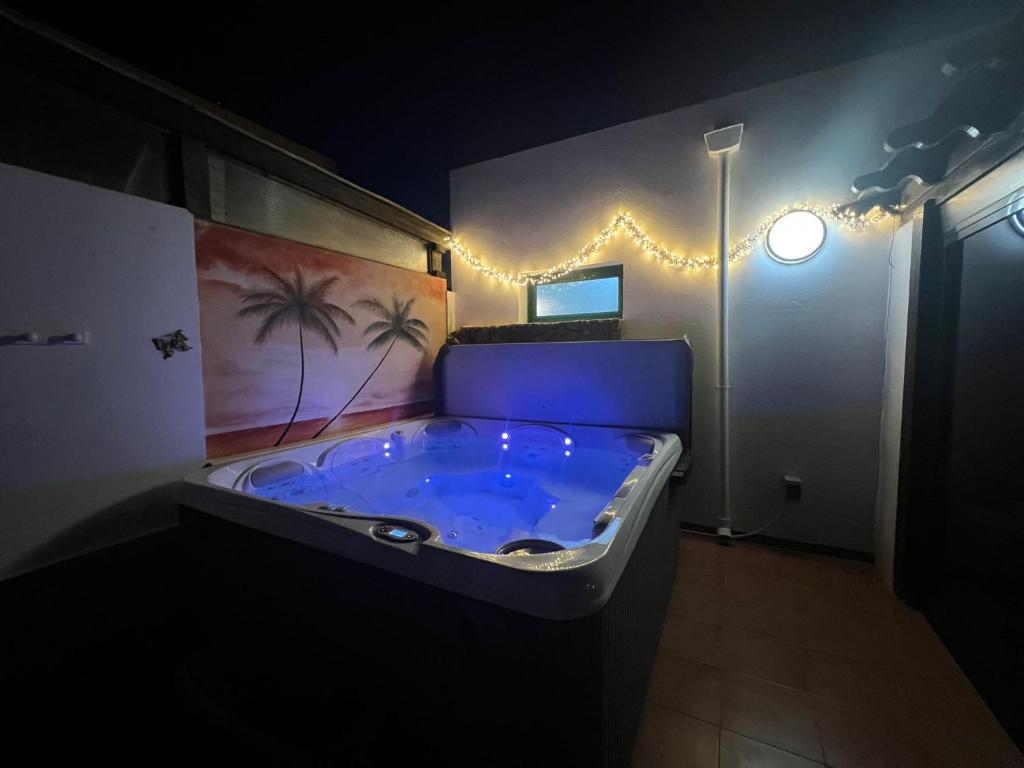 a large jacuzzi tub in a room with lights at CASA ORILLA! Beautiful private holiday villa with hot tub in La Oliva
