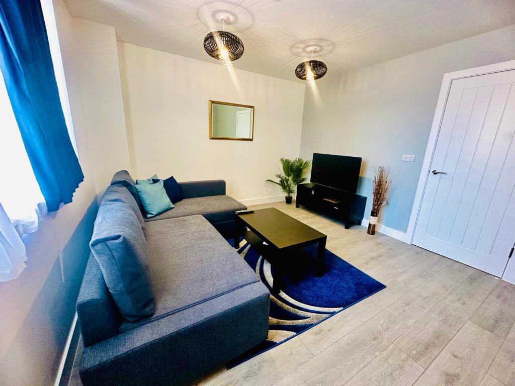 a living room with a couch and a table at Hemel Apartments - Sea Breeze in Hemel Hempstead