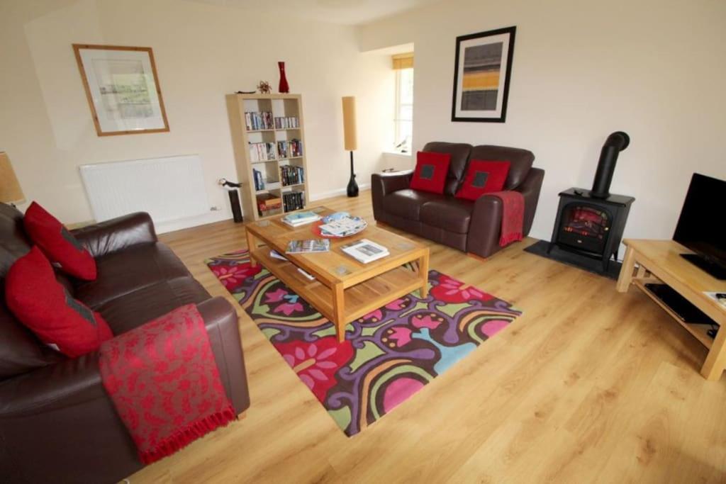 a living room with a couch and a coffee table at Castle View Stornoway in Stornoway