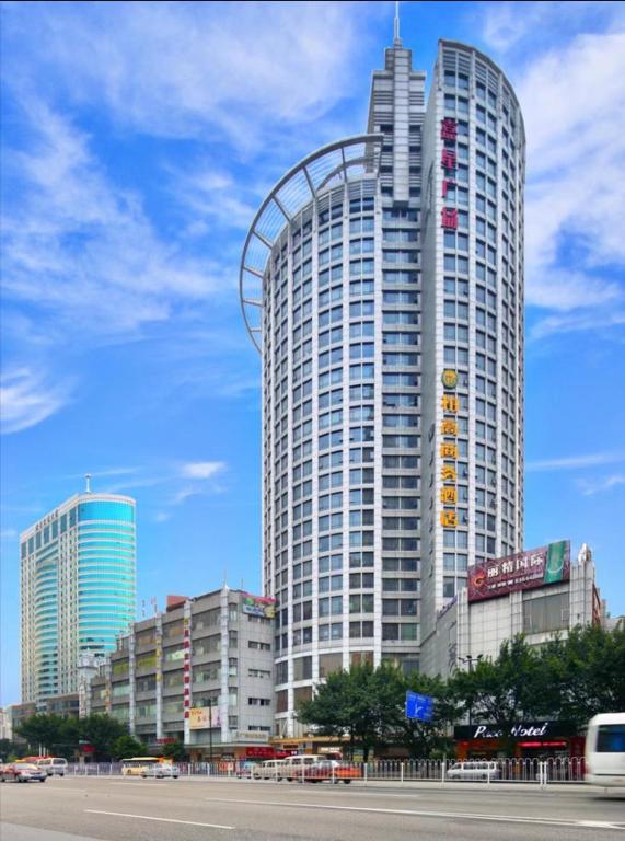 a tall building with a roller coaster on top of it at Paco Hotel Yan Jiang Road Tuan Yi Da Metro Guangzhou-Free shuttle bus to Canton Fair in Guangzhou
