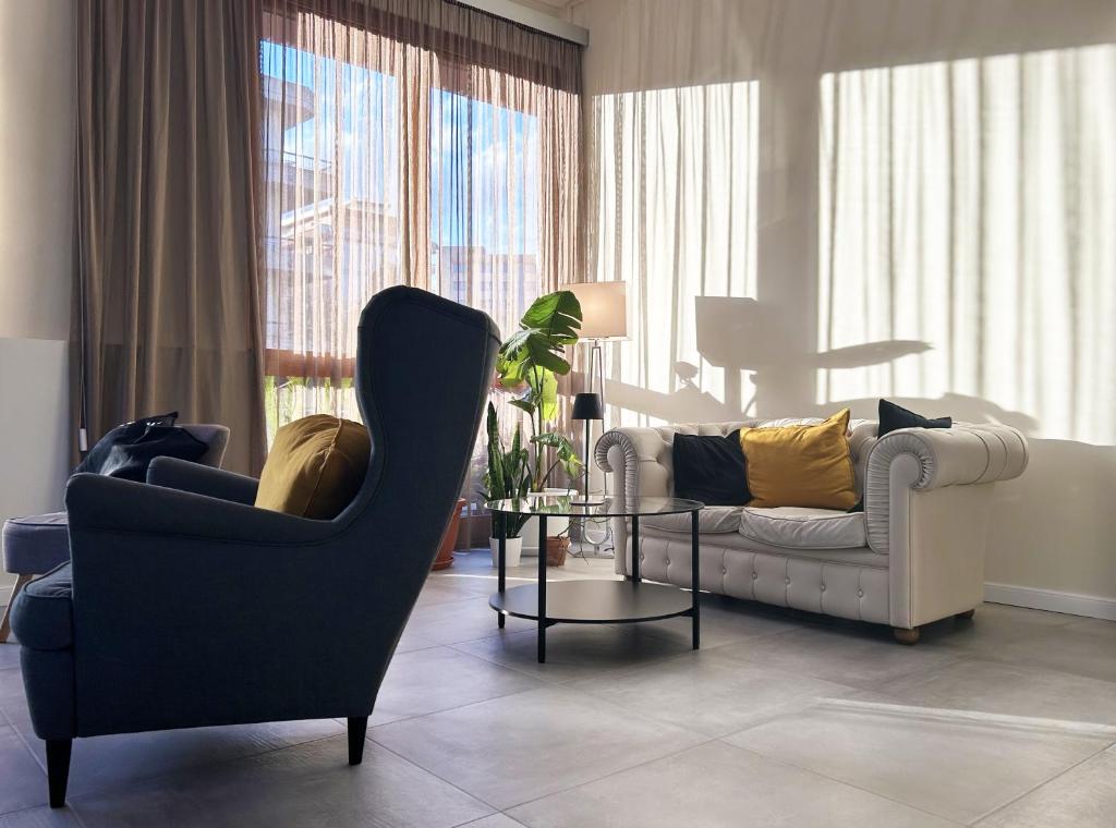 a living room with two chairs and a table at Hotel Franchi in Florence