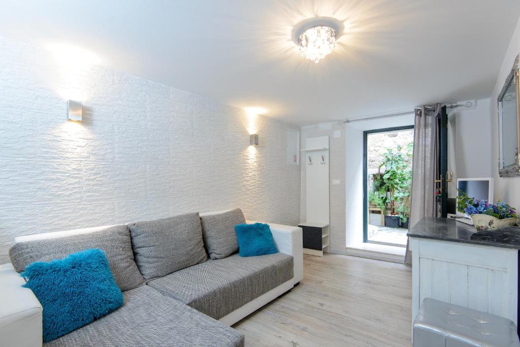 a living room with a couch and a window at Apartment Brilliant in Dubrovnik