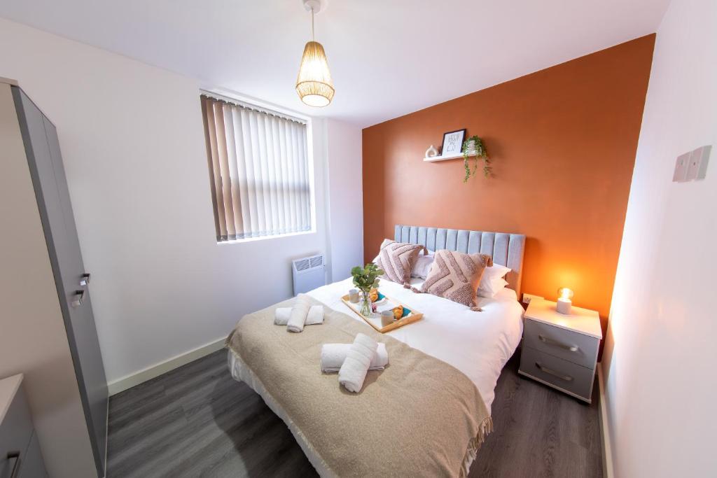 a bedroom with a large bed with two towels on it at Cosy 1 bed in Stockport centre in Stockport