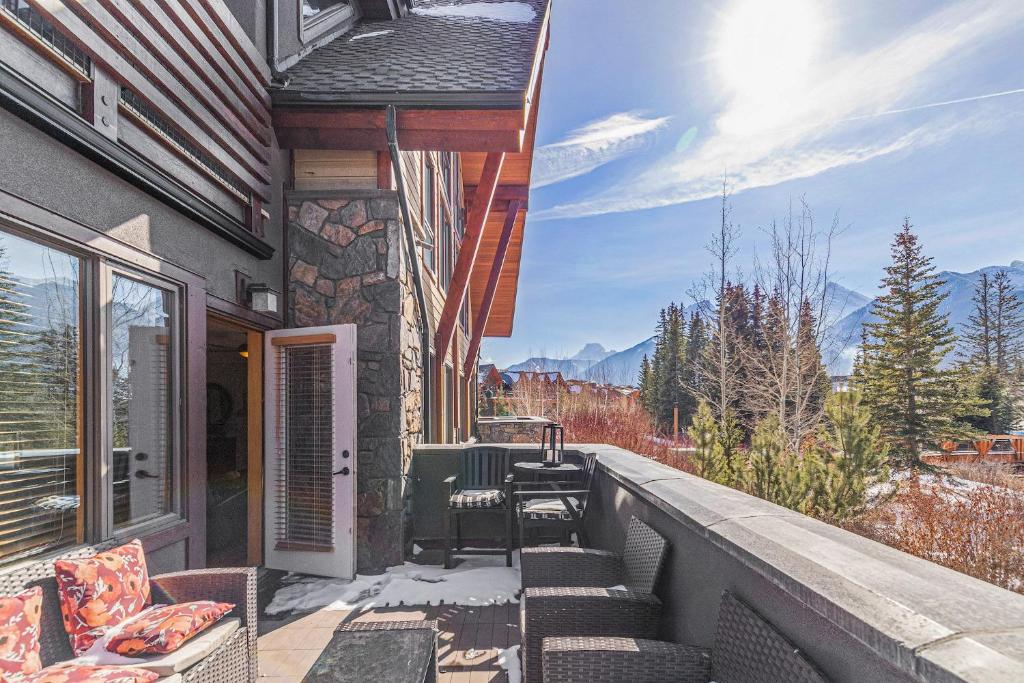 a balcony with chairs and a view of the mountains at Spring Creek Condo by Canadian Rockies Vacation Rentals in Canmore