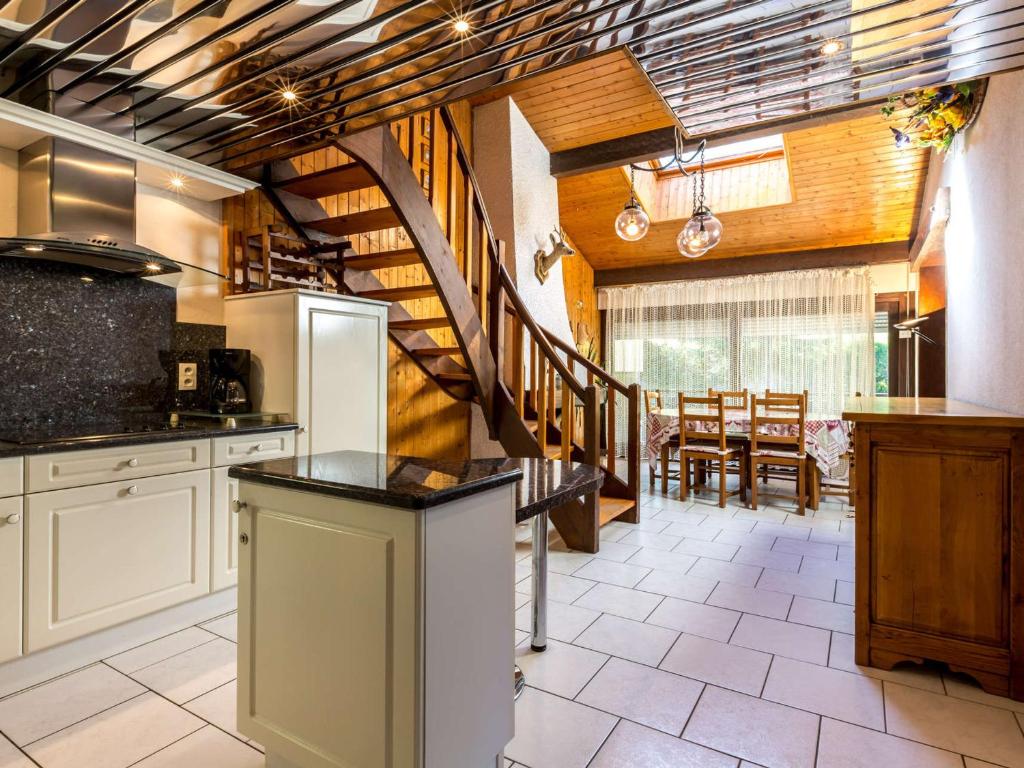 a kitchen with a staircase leading to a dining room at Appartement La Clusaz, 3 pièces, 5 personnes - FR-1-437-28 in La Clusaz
