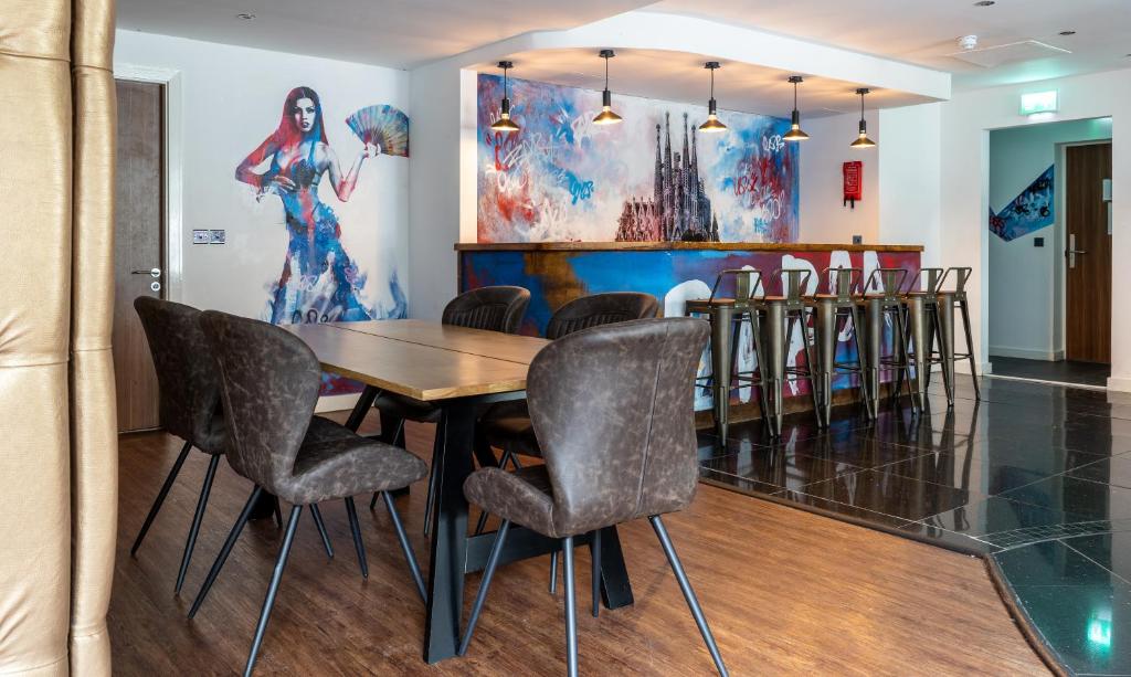 a dining room with a table and chairs at The Bling Hotel by UStay Aparthotels in Liverpool