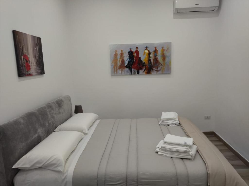 a bed in a white room with at Casa Lucia in Bari