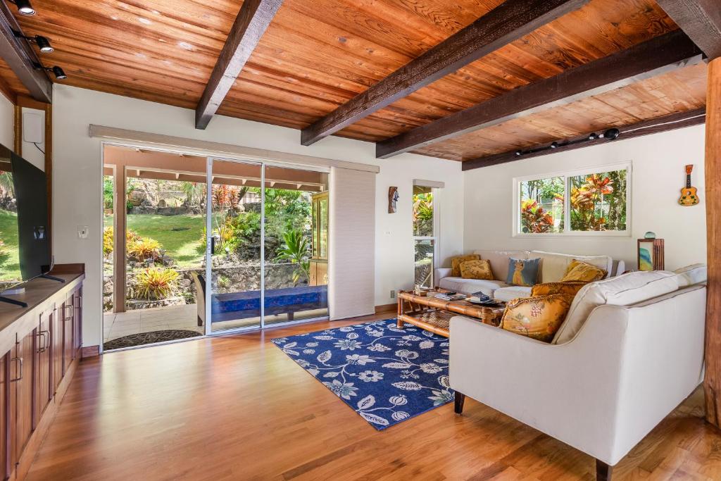 a living room with a white couch and a blue rug at Seabreeze Hawaii Kai - 30-Night Minimum in Honolulu