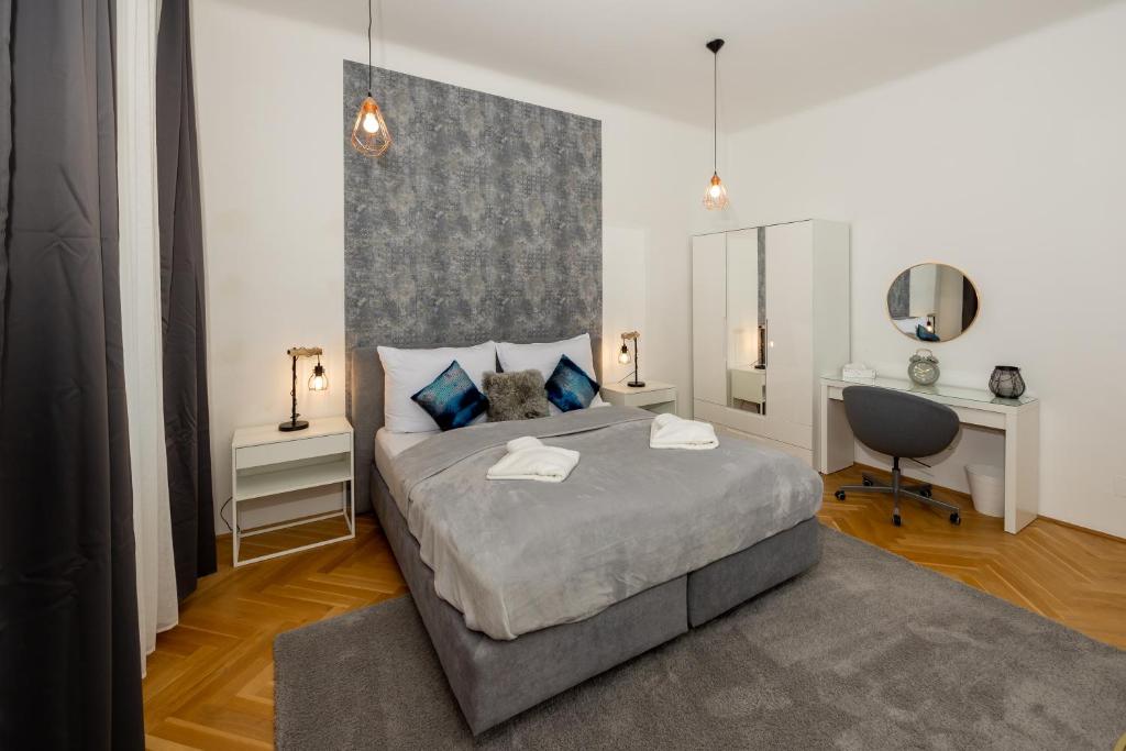 Hotel Delightful 1 bedroom near Schönbrunn and Westbahnhof with big porch, a bedroom with a large bed and a desk at Delightful 1 bedroom near Schönbrunn and Westbahnhof with big porch in Vienna
