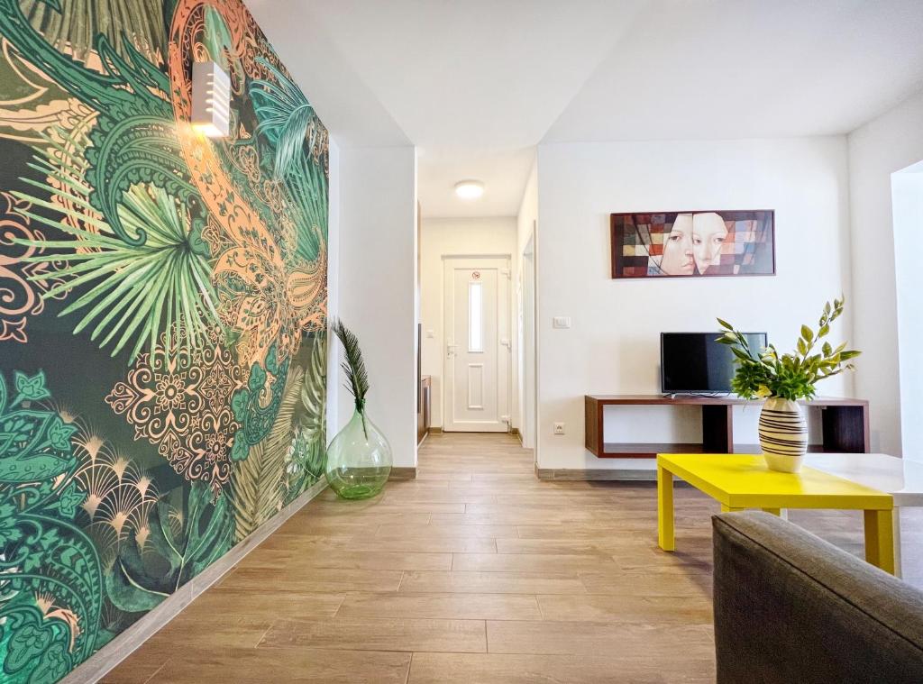 a living room with a large mural on the wall at Apartments Teodora Maria in Novigrad Istria