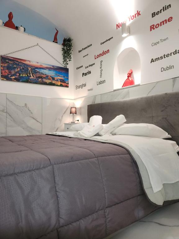 a bedroom with a large bed in front of a wall at Suite SAN GENNARO in Naples