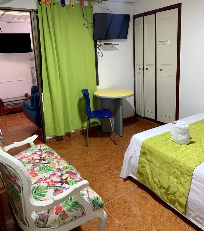Postel nebo postele na pokoji v ubytování Hotel Mi Casita Pereira
