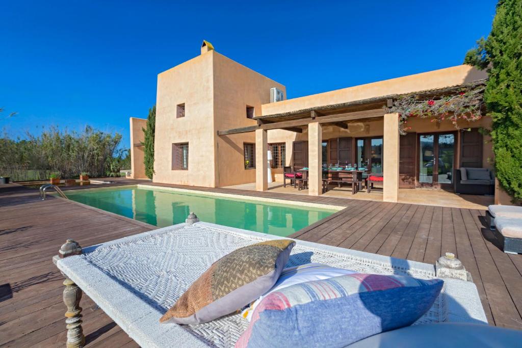 a house with a swimming pool and a patio at Lontananza in Sant Francesc Xavier