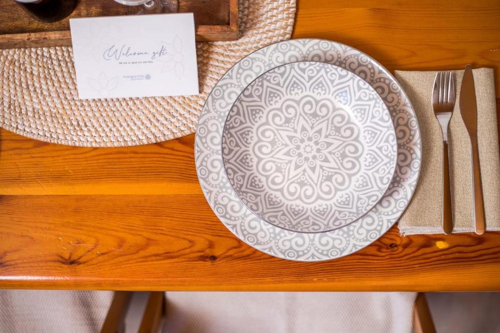 a plate on a table with a napkin and fork and knife at Margaritas apartments in Symi