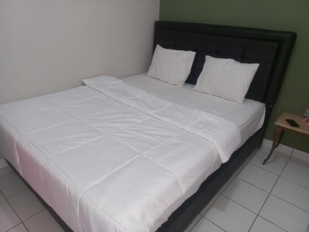 Voodi või voodid majutusasutuse SPOT ON 92415 Bima House Syariah toas