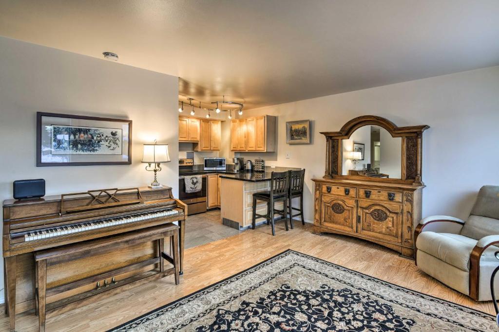 a living room with a piano and a kitchen at Anchorage Vacation Rental in Walkable Area! in Anchorage