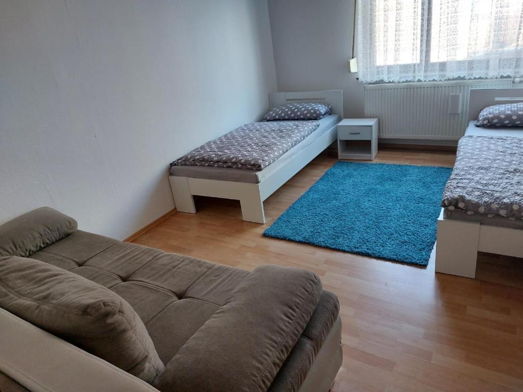 a living room with a couch and a blue rug at Ferienwohnung Enz 