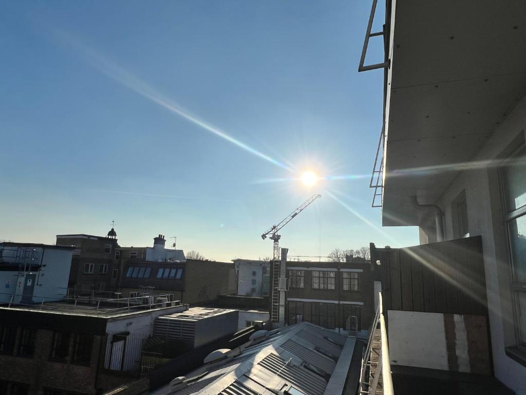 a view of a city with a crane in the sky at Room with share bathroom in London