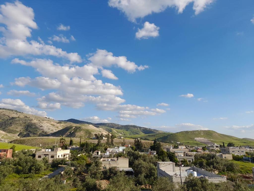 a town in the mountains under a blue sky with clouds at Pella Countryside hotel 