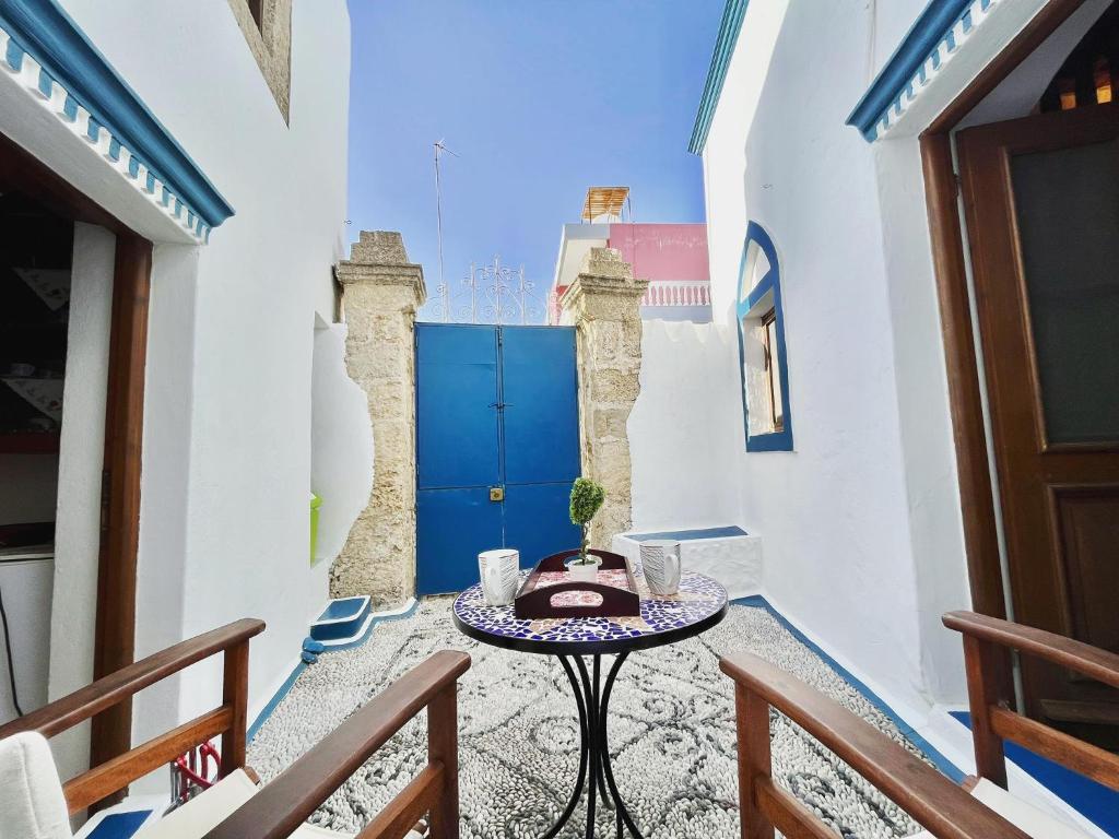 a room with a table and a blue door at Traditional house in Koskinou in Koskinou