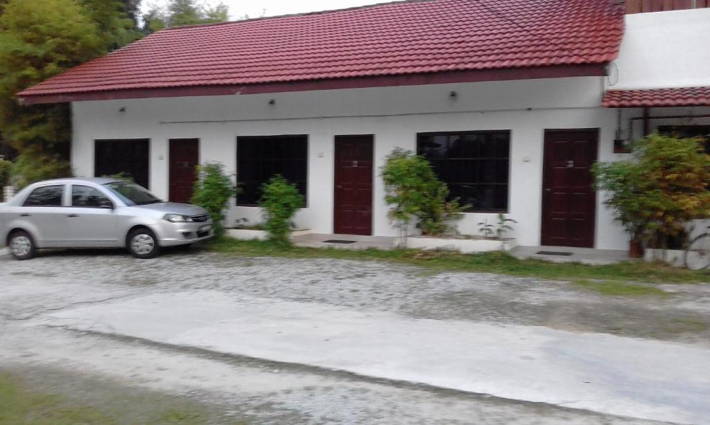 un coche aparcado frente a una casa en MELATI INN en Kajang