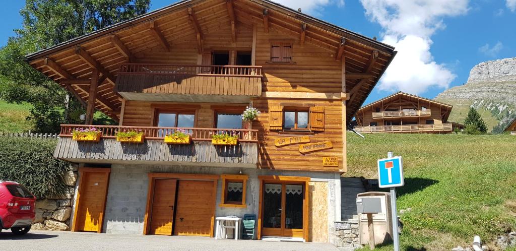 een houten huis met een balkon op een berg bij Studio pour petite famille in Le Grand-Bornand