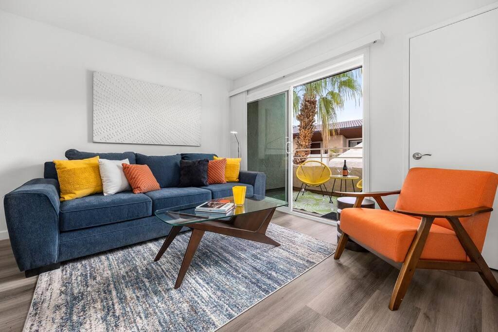 a living room with a blue couch and an orange chair at The 1 at Biarritz-Remodeled 1 br in Downtown PS in Palm Springs