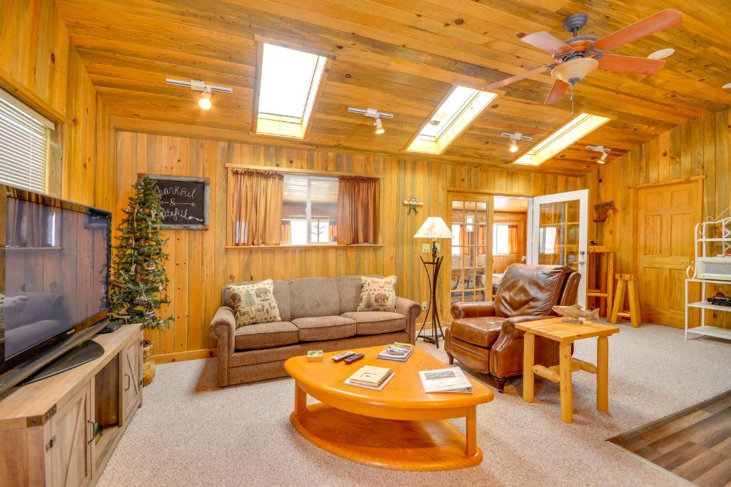 a living room with a couch and a table at Cody Vacation Rental Near Cedar Mountain! in Cody