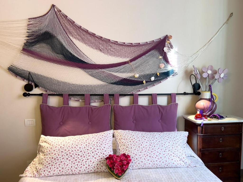 a bedroom with a bed with a canopy above it at La piccola casa di Ubs in Sestri Levante