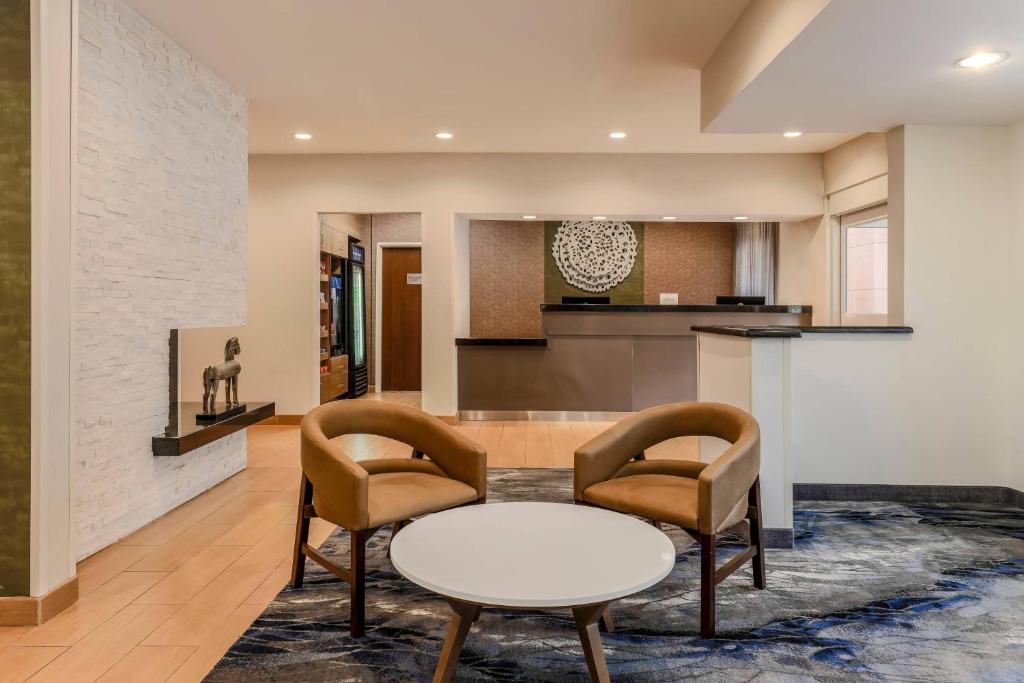 a living room with a table and two chairs at Fairfield Inn & Suites Houston Westchase in Houston