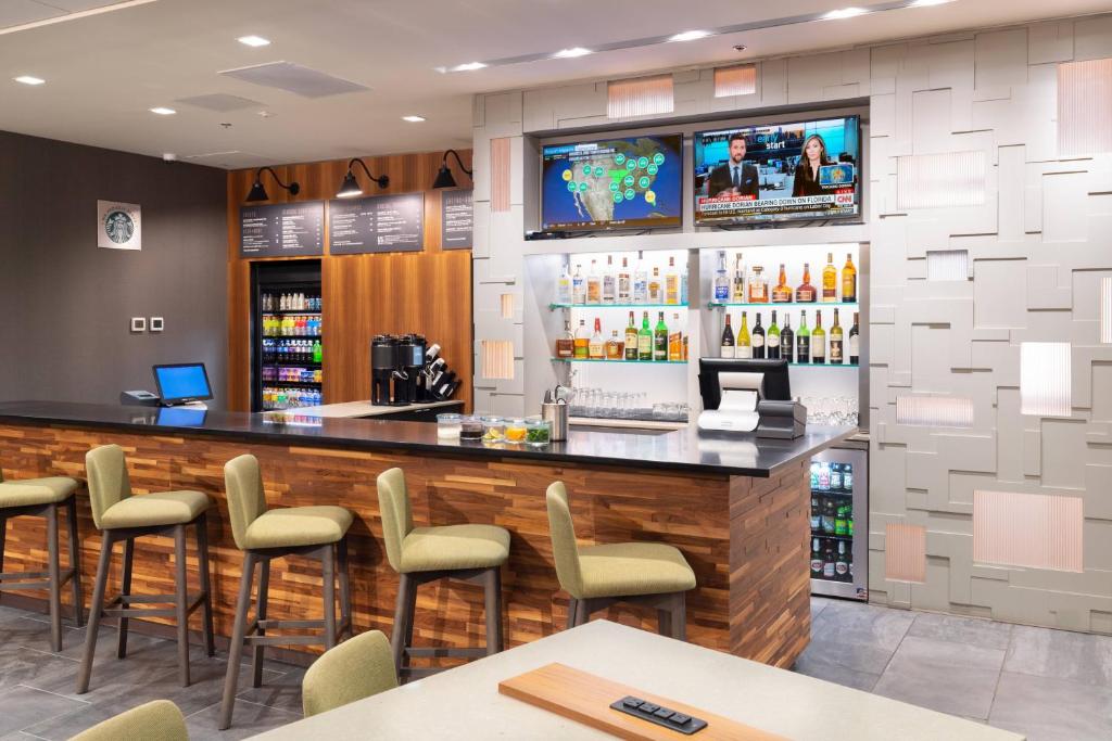 a bar in a restaurant with chairs and a counter at Courtyard by Marriott Bowie in Bowie