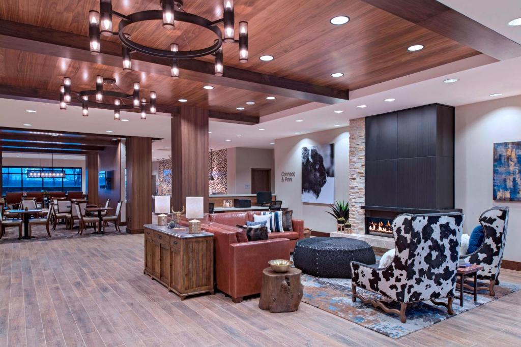 a lobby with a waiting area with chairs and tables at Fairfield Inn & Suites by Marriott Cheyenne Southwest/Downtown Area in Cheyenne